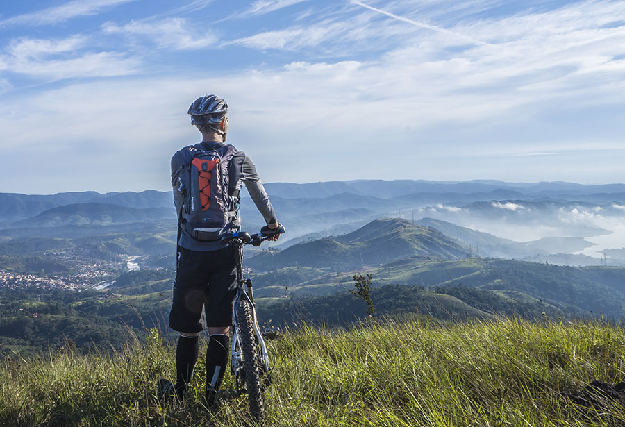 single biker overlooking valley