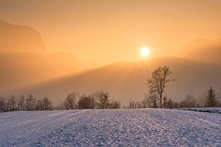 sunrise over a snowy field